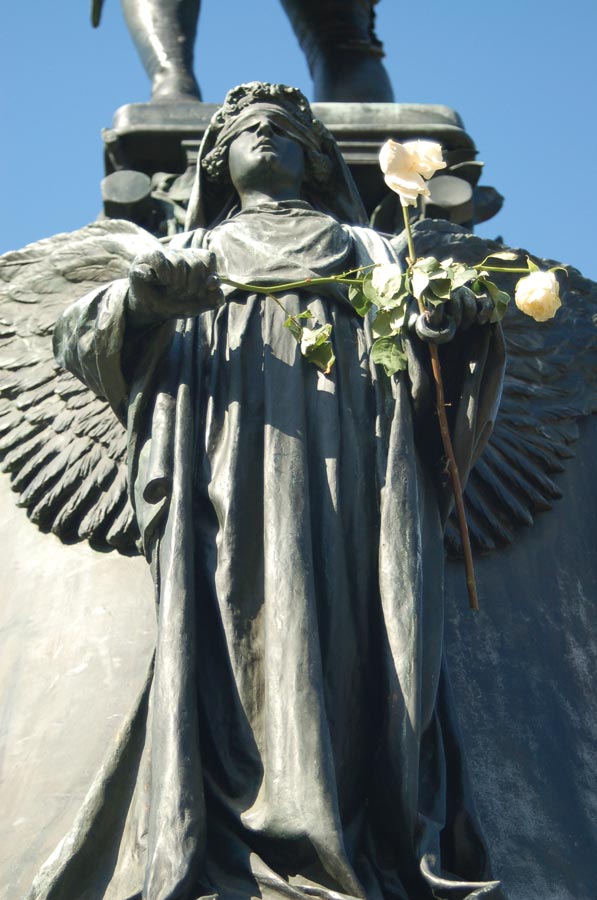 White roses placed on the angels surrounding the Jefferson statue in front of the Rotunda’s north steps