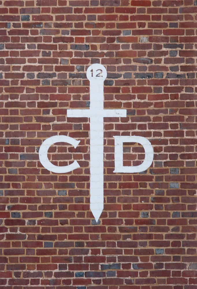 Order of the Claw & Dagger logo painted on the side of a building