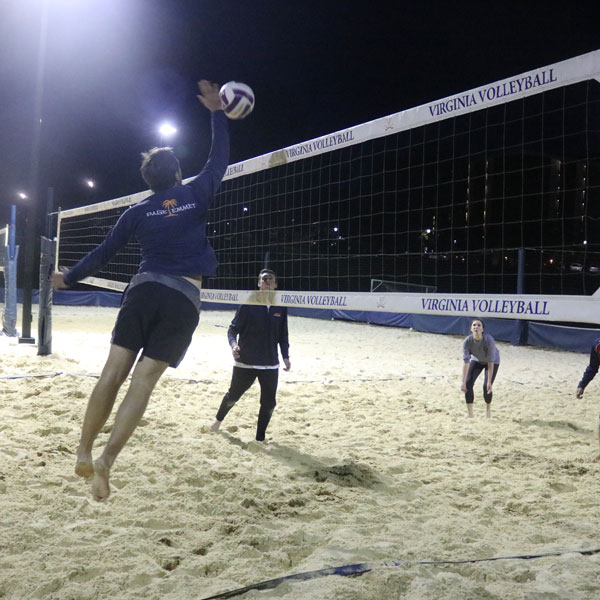 Students playing sand volleyball