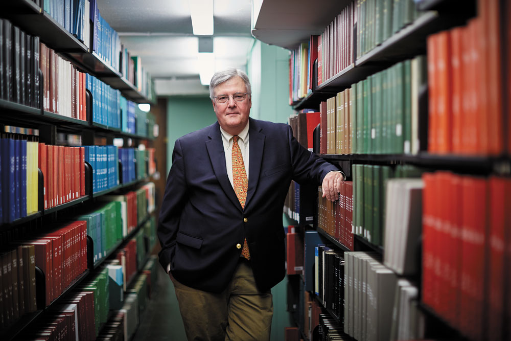 Dean of Libraries John M. Unsworth amid Old Stacks’ metal support shelves
