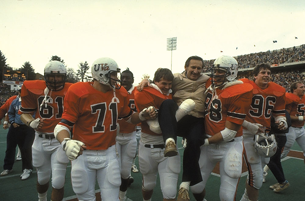 Players carry coach Welsh off the field after a 17-14 win in 1983 snaps a 9-game losing streak against UNC.