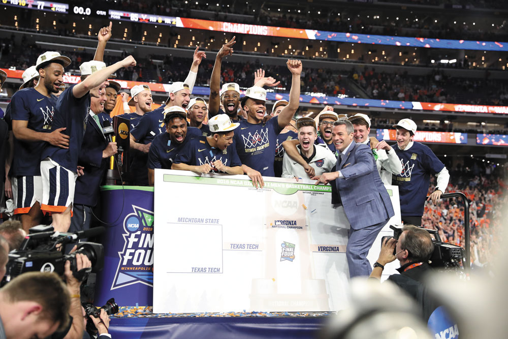 Bennett places the “Virginia” sticker in the final spot on the team’s bracket