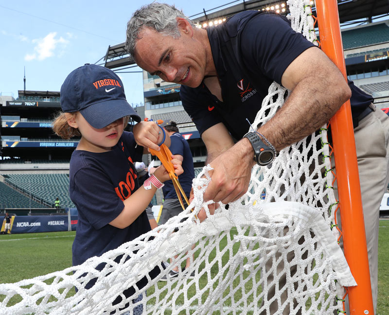 Coach Lars Tiffany and his son cut the net.
