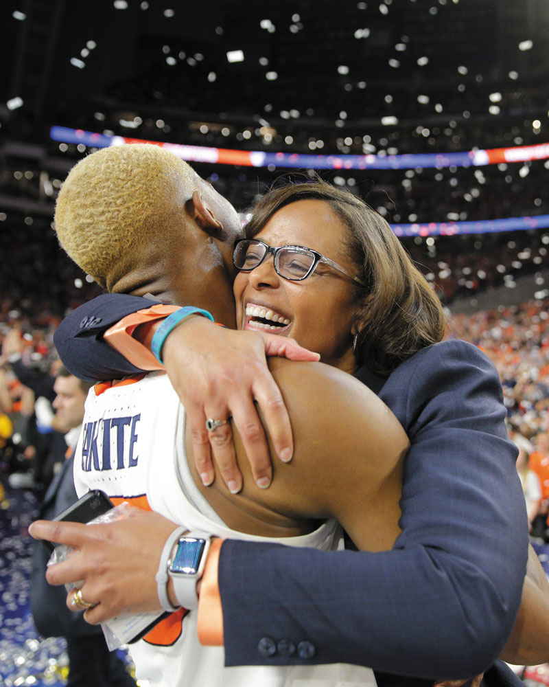 Mamadi Diakite and Carla Williams hug after the men’s basketball team won the national championship