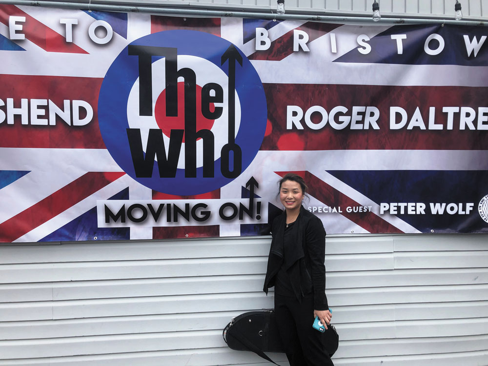 Olivia Scheidt in front of a The Who poster