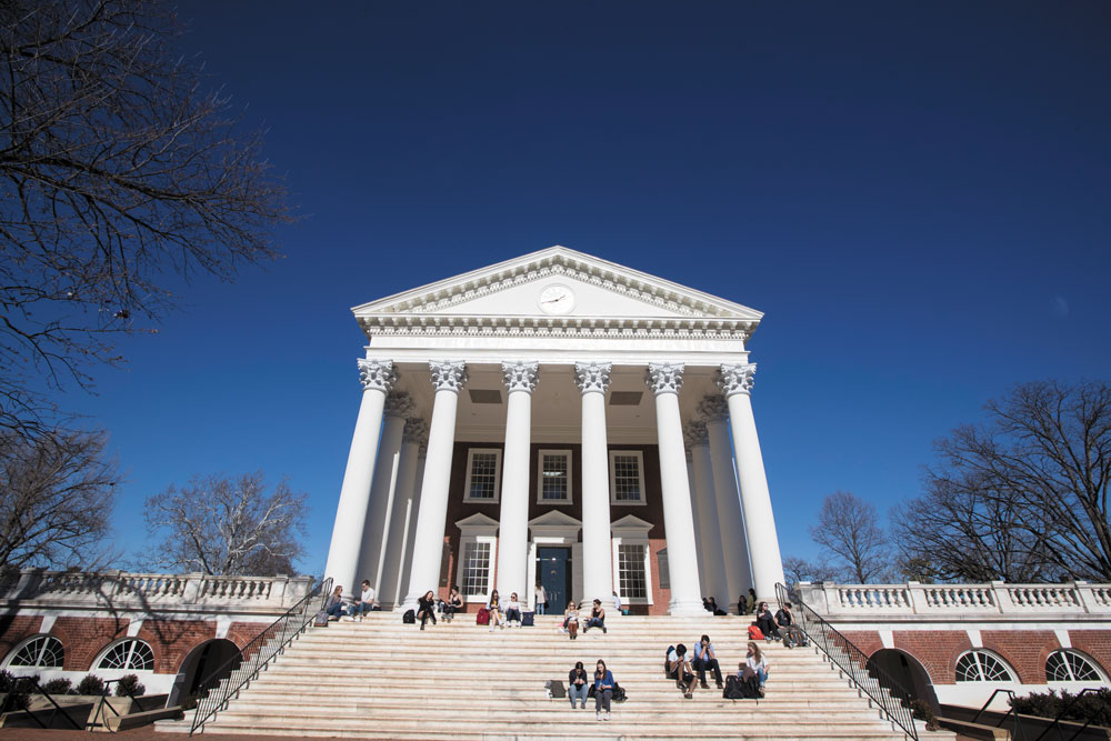 Students sitting on the steps of the Rotunda on a blue-sky day