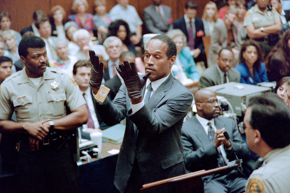 O.J. Simpson attempts to put on the infamous gloves during his trial