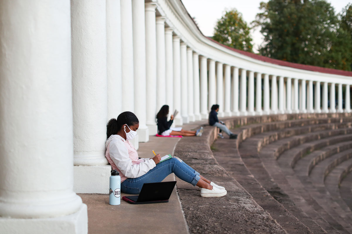 Students doing schoolwork while sitting on the steps of the Lambeth colonnade