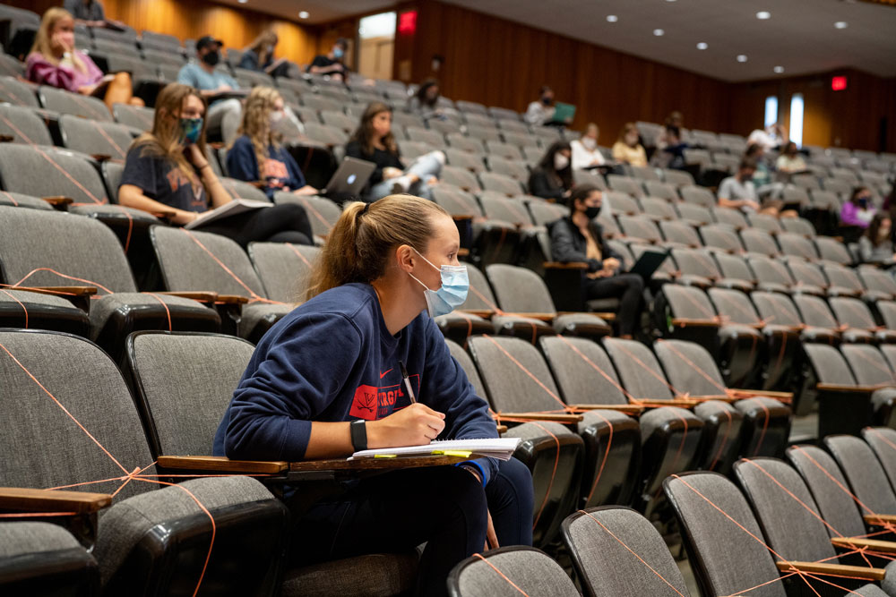 Masked, distanced students attend a lecture class