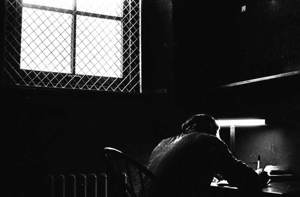 Black-and-white photo of a student in a Clark Hall library carrel