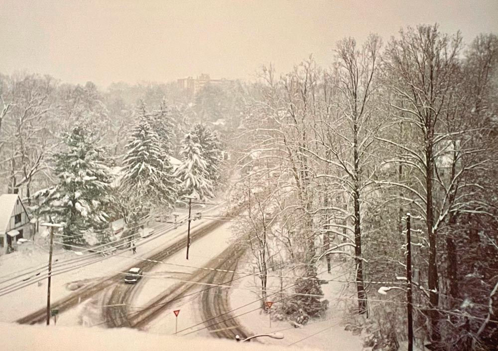 View of a snowy streetscape as seen from the roof of the Math Astronomy Building