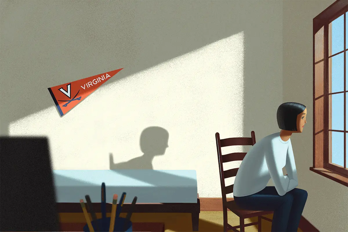 UVA student looks out window in dorm room